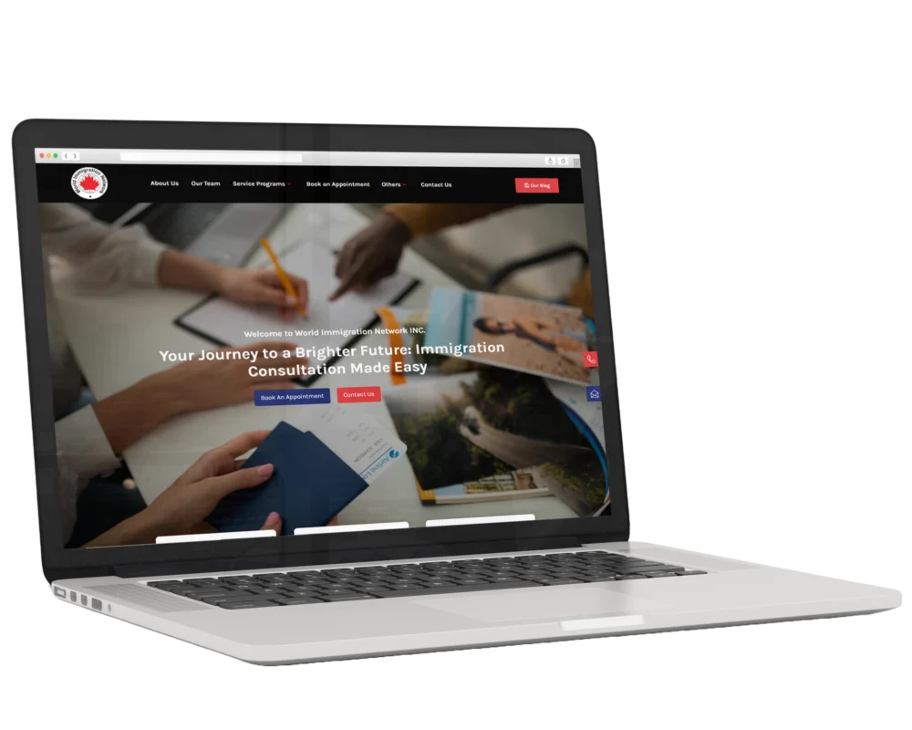 Laptop displaying an immigration consultancy website homepage